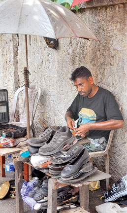 cobbler mending shoes